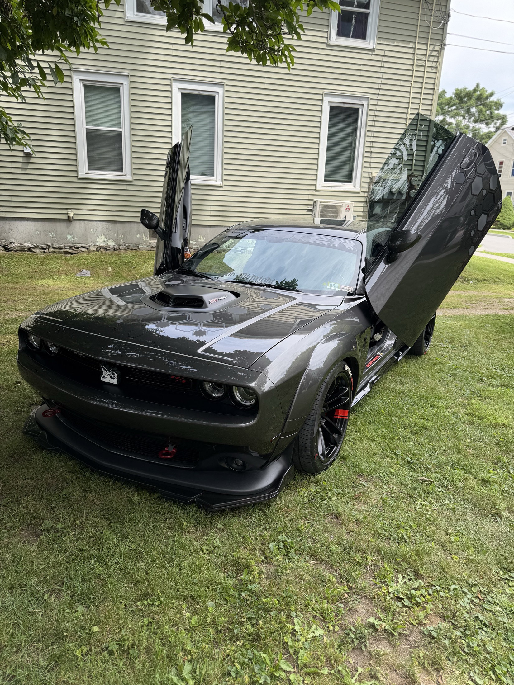A gunmetal widebody muscle car detailed by Keefe’s Kustoms, doors raised